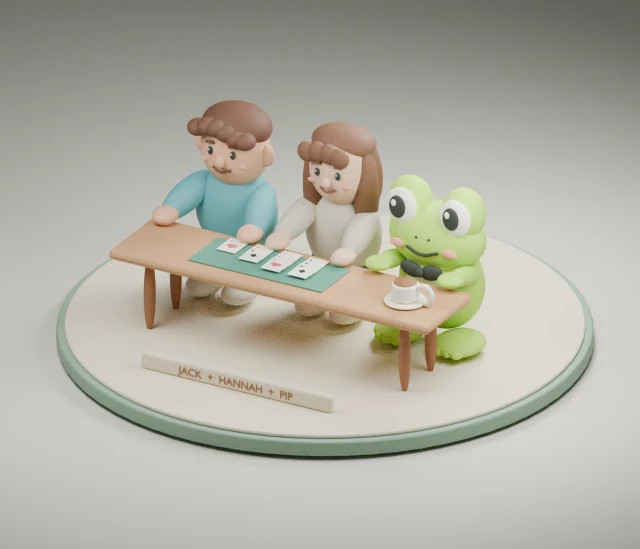 Two stylised human figures and a green frog sit at a table on a circular plinth, with a personal-name plaque at the front.